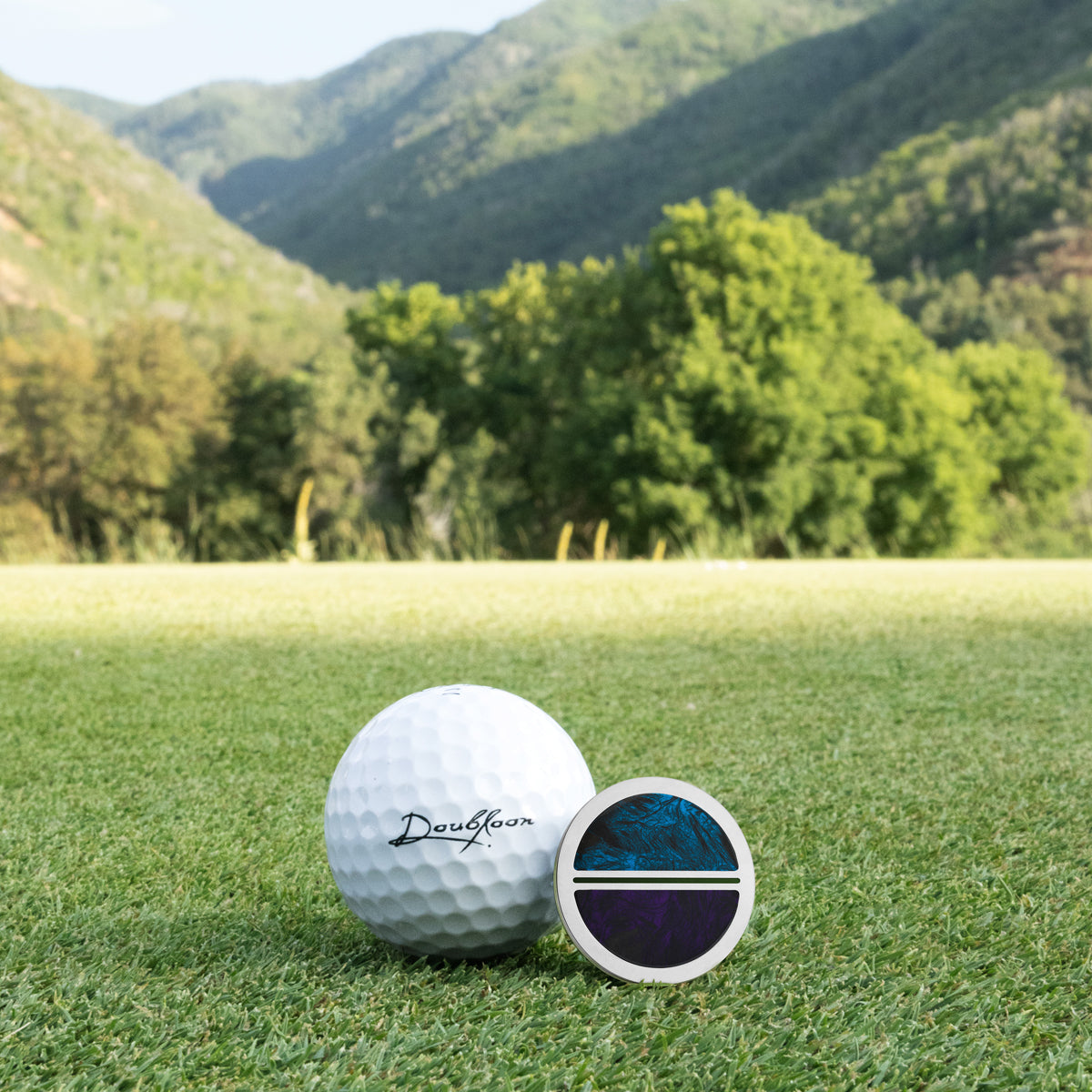 The Jester Golf Ball Marker — alternate angle showing carbon fiber and titanium finish