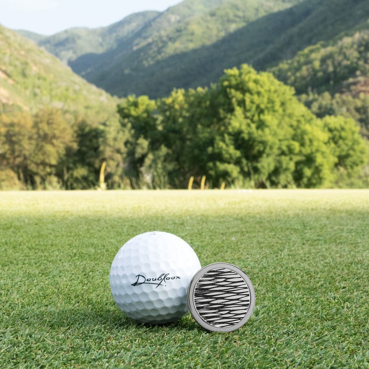 The Stealth Golf Ball Marker — alternate angle showing sterling silver and tungsten finish
