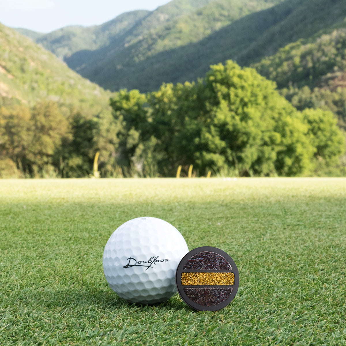 The Rex Premier Golf Ball Marker — alternate angle showing dinosaur bone and gold and titanium finish