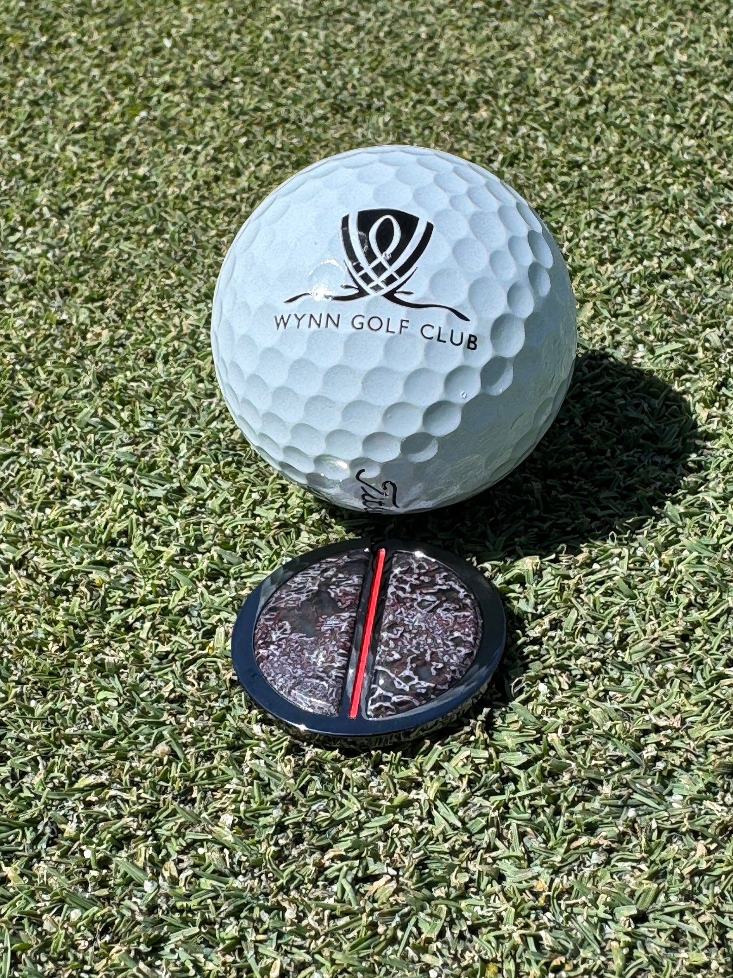 The Jurassic Golf Ball Marker — luxury marker on putting green