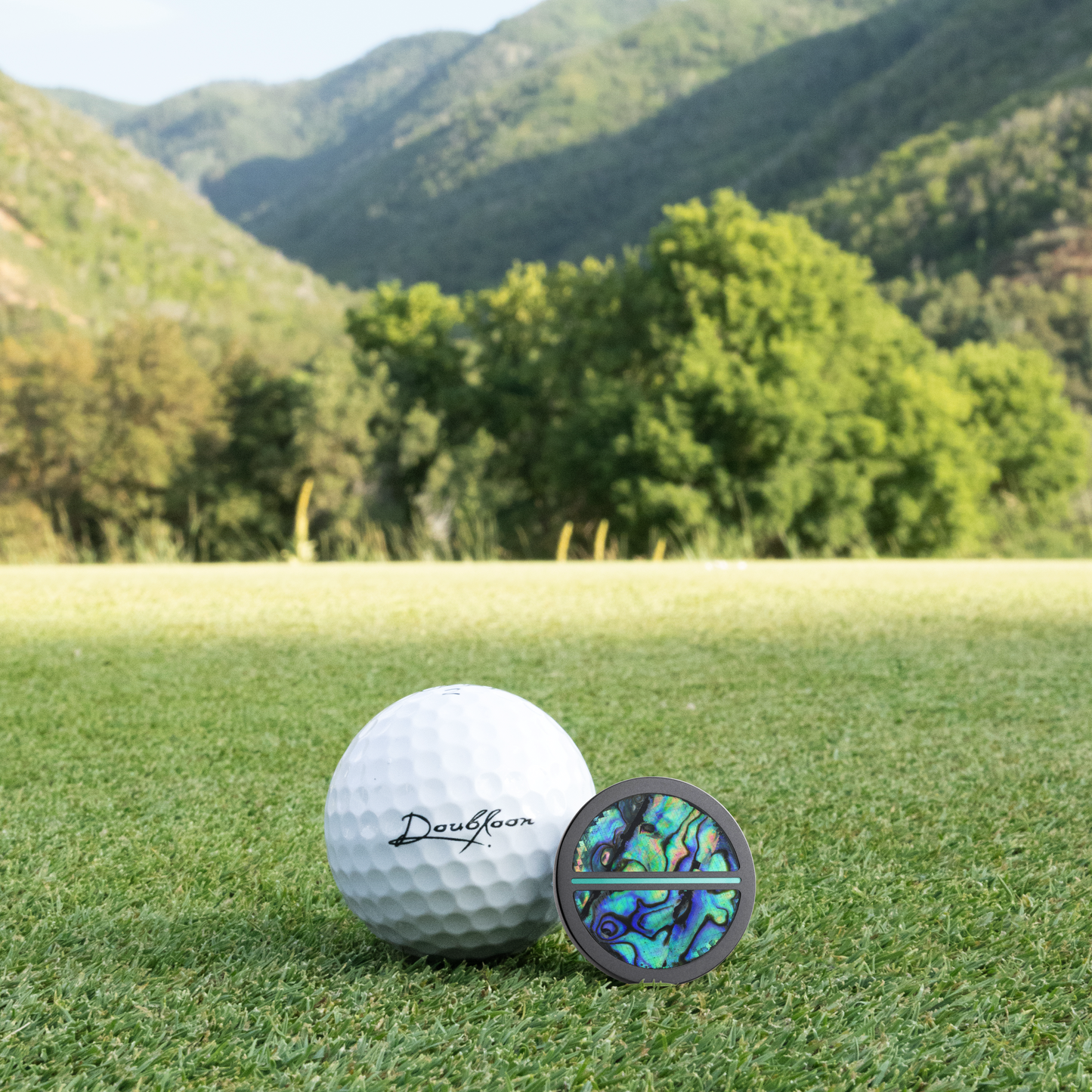 The Leviathan Golf Ball Marker — scale comparison showing 30mm diameter