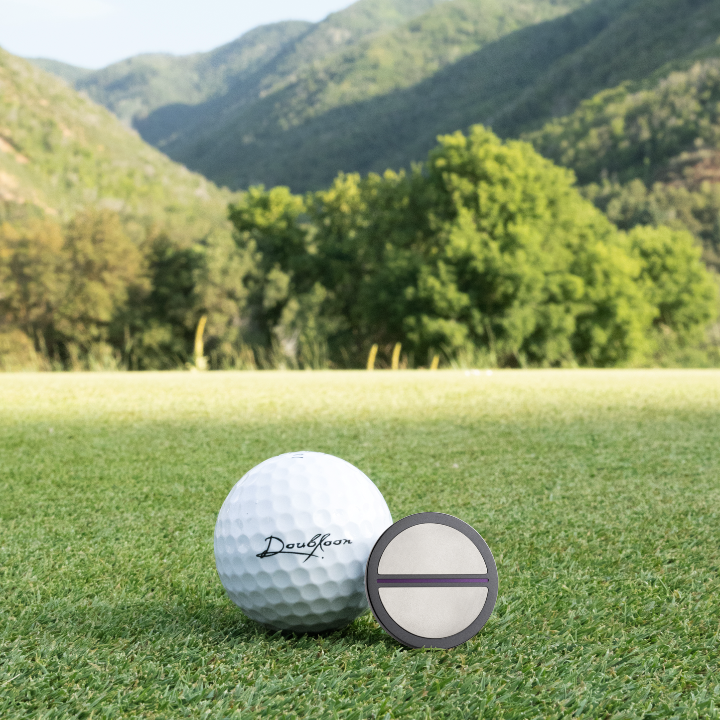 The Morado Golf Ball Marker — scale comparison showing 30mm diameter