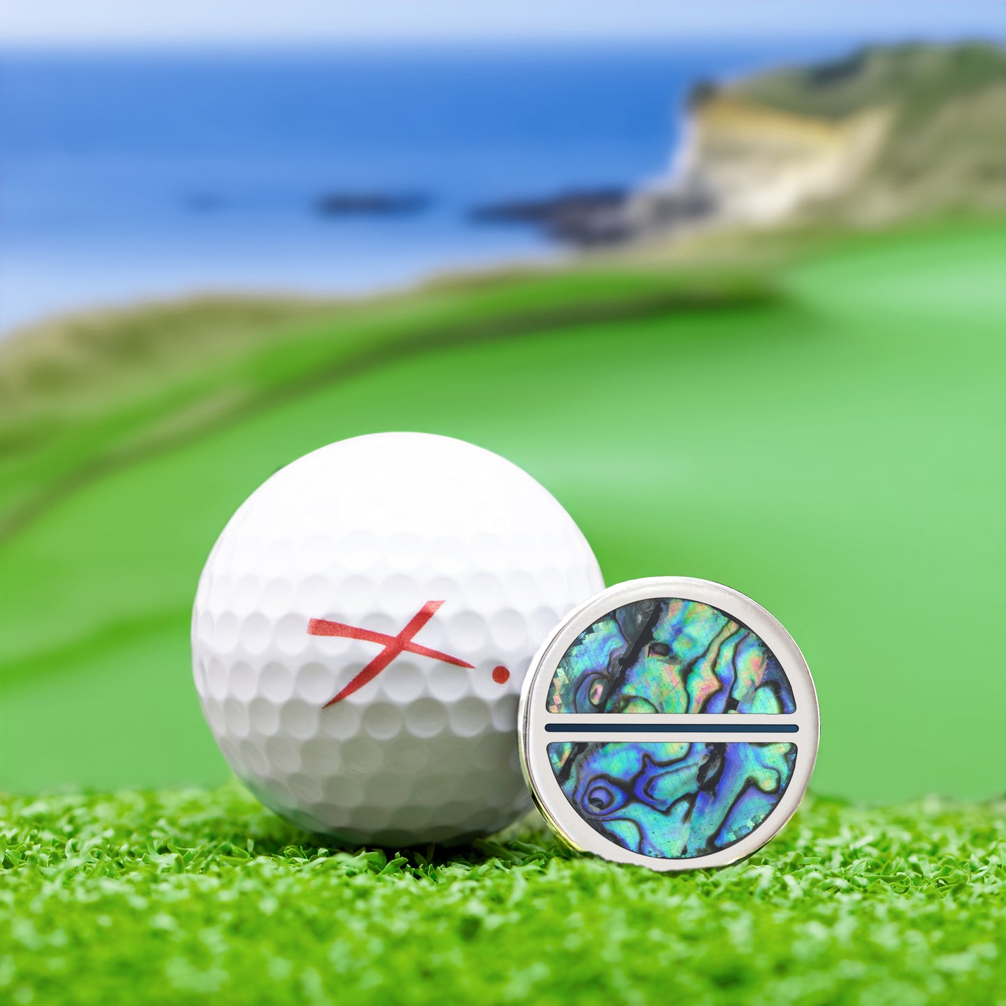 The Shell Golf Ball Marker — alternate angle showing abalone and titanium finish