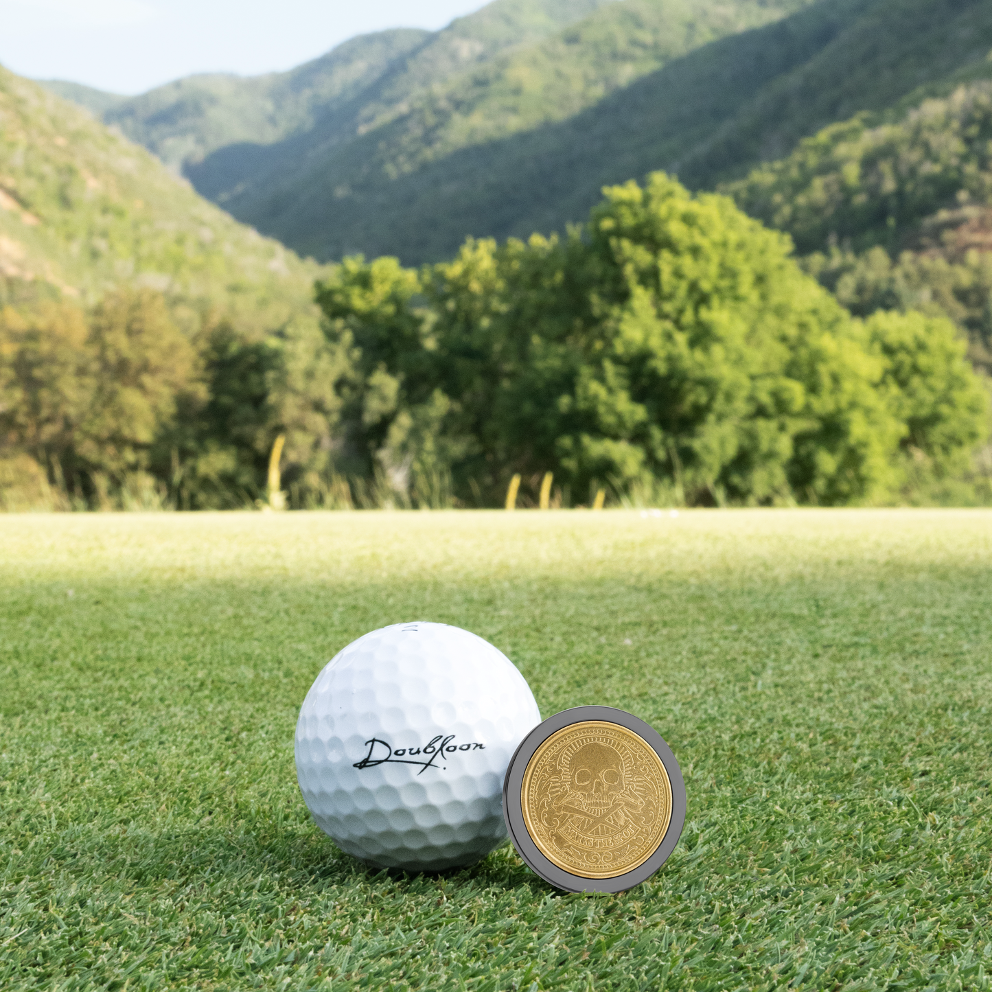 The Omen II Golf Ball Marker — alternate angle showing sterling silver and titanium finish