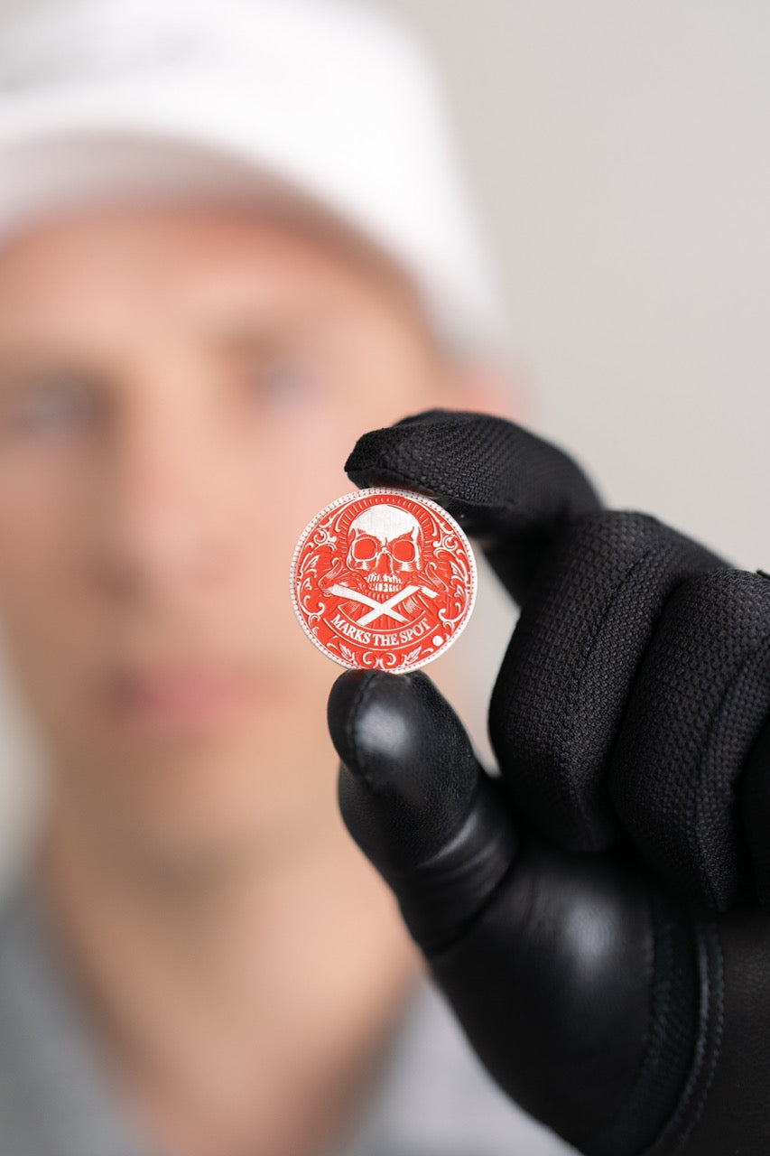 The Silver Omen Antique, Color Edition Golf Ball Marker — orange variant lifestyle shot